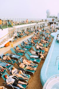 A group of people in lawn chairs on a cruise ship.